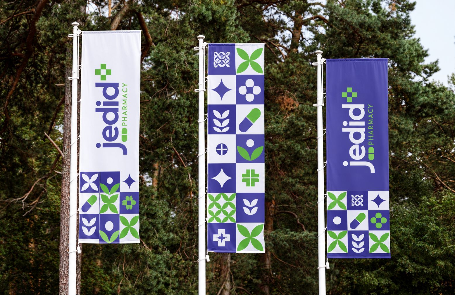 Three Jedid pole banners with the logo and pattern